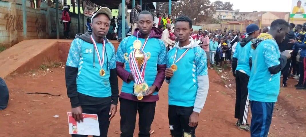 our able team manager sammy munyoki with team certificate medals  and trouphy